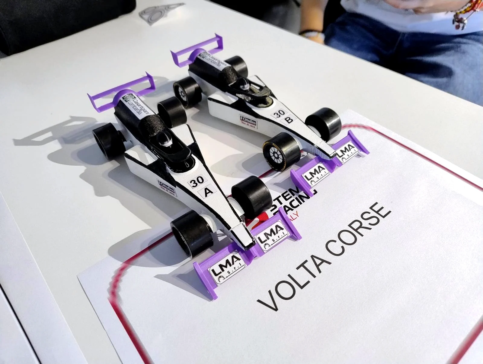 Due monoposto in scala del progetto Volta Corse sulla pista di gara